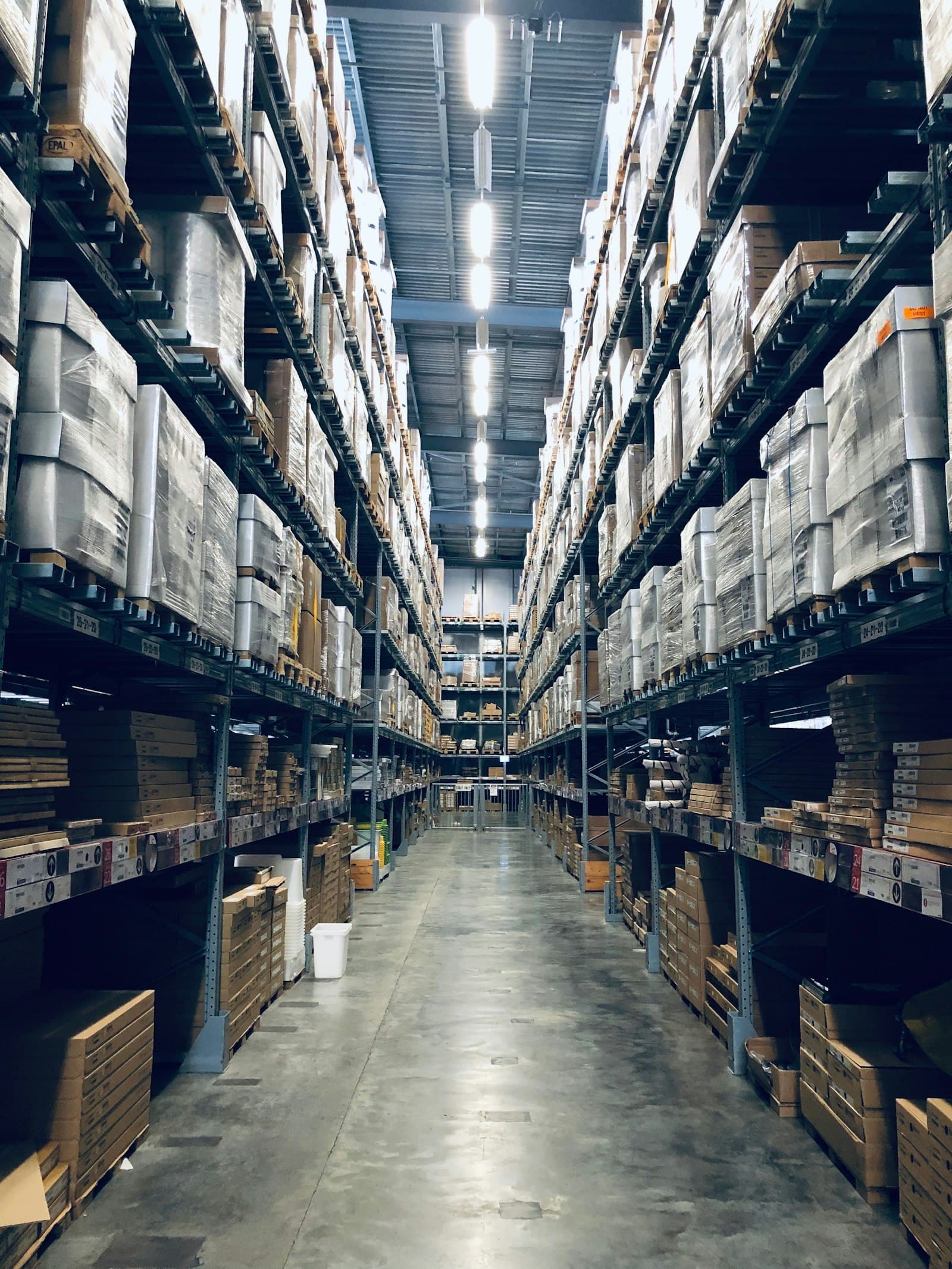 Rows of shelving stacked with cartons inside a fulfillment warehouse